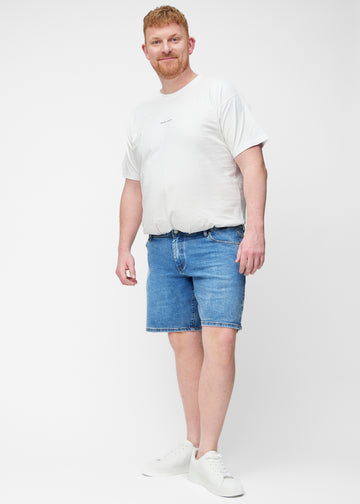 Full image of a plus-size model wearing blue denim shorts for men in the colour Rivers with a regular fit.