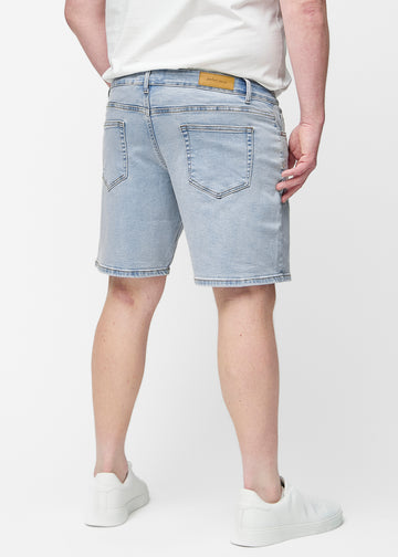 Light blue denim shorts for men in the colour Waves seen from the back on a plus-size model, showing the length just above the knee.
