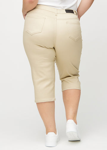 Beige regular capris seen from the back on a plus-size model, so the full product can be seen.