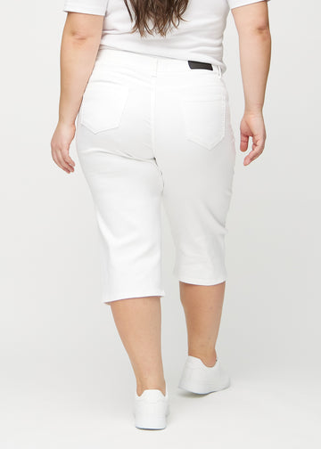 White regular capris seen from the back on a plus-size model, so the entire product can be seen.