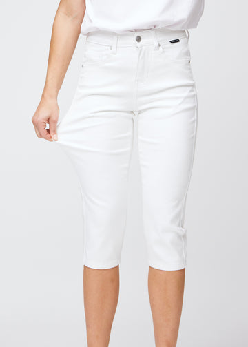 The model stretches the capris at the thigh to show the soft and flexible stretch.