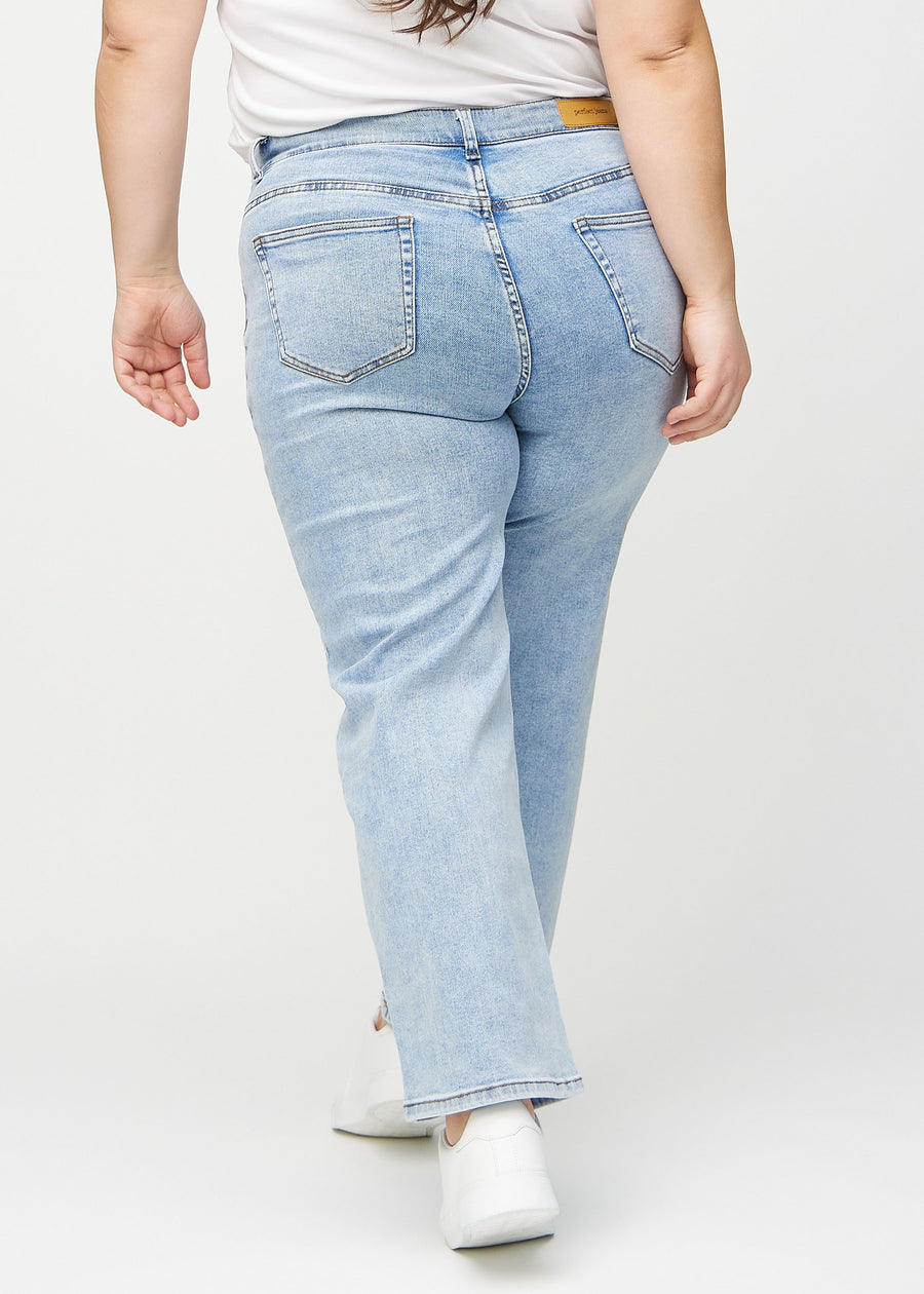 Light denim loose jeans seen from the back on a plus-size model, so the entire product can be seen.