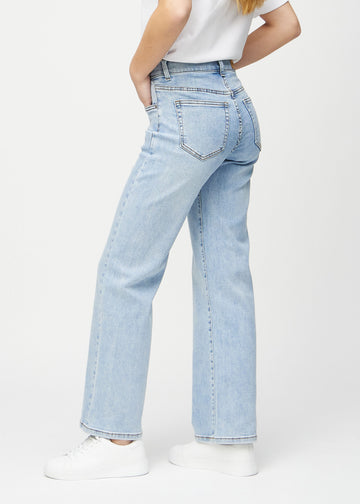 Light denim loose jeans seen from the side on a model.