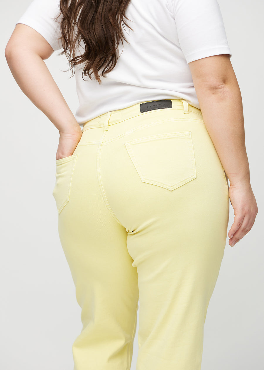 Regular jeans for women in light yellow, color Lemonades. Close-up from behind on a plus-size model, showing fit and details.