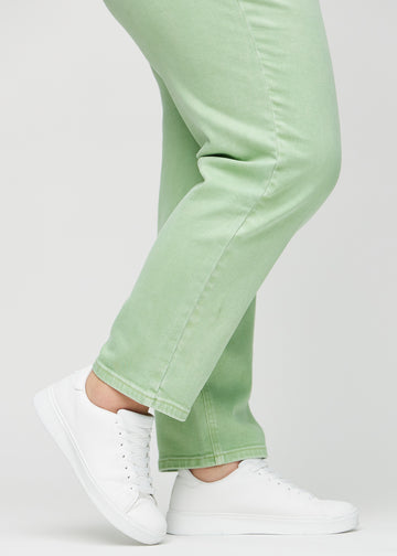 Regular jeans for women in light green, color Mints. Close-up at the ankles on a plus-size model, showing the straight leg openings.