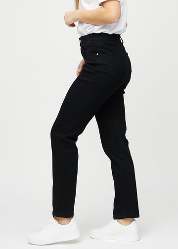 Black regular jeans seen from the side on a model.