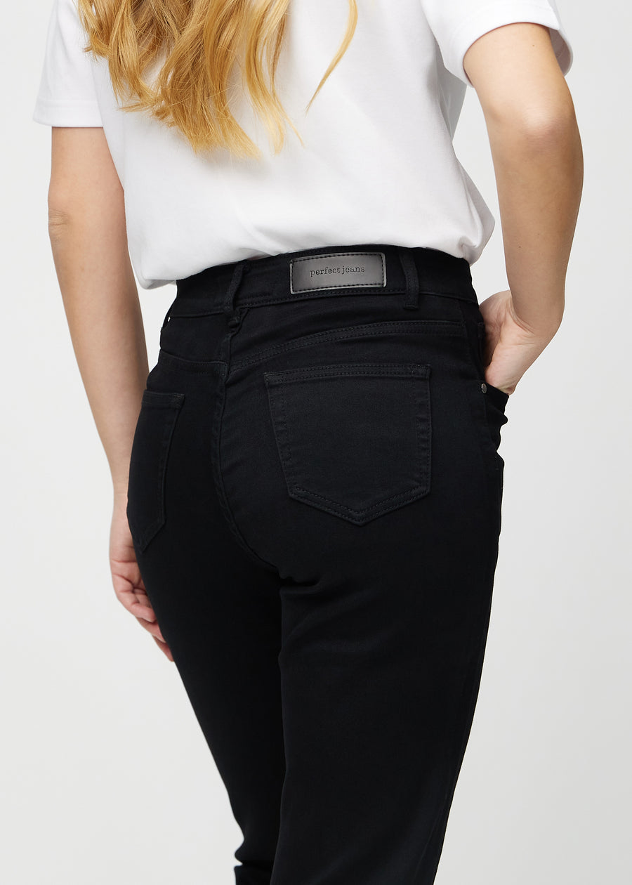Black regular jeans seen from the back close up to show details.
