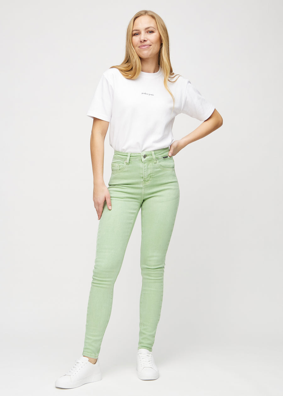 Skinny jeans for women in light green, color Mints. Full-length view of a model in the jeans.