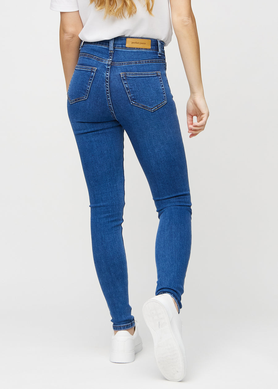 Skinny jeans for women in dark blue, color Oceans. Back view on a model, showing the full fit.