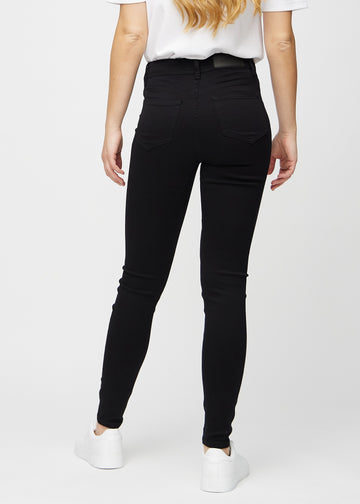 Black skinny jeans seen from the back, so the full product can be seen.