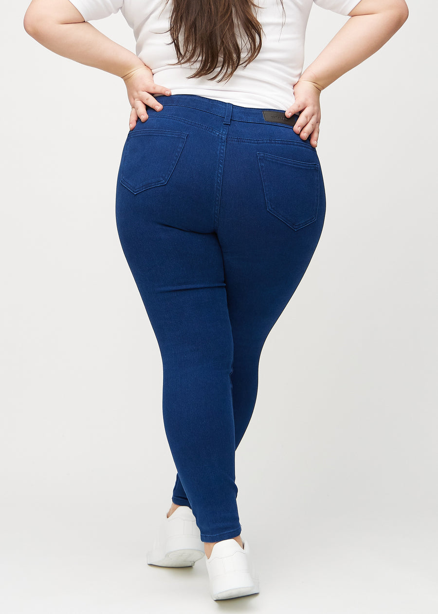 Skinny jeans for women in dark blue, color Royals. Back view on a plus-size model, showing the overall fit.