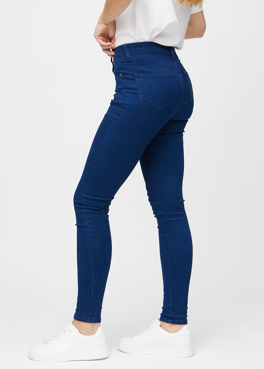 Skinny jeans for women in dark blue, color Royals. Side view on a model.