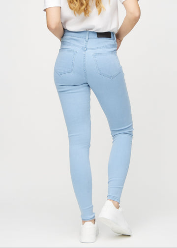 Skinny jeans for women in light blue, color Skies. Back view on a model, showing the overall fit.