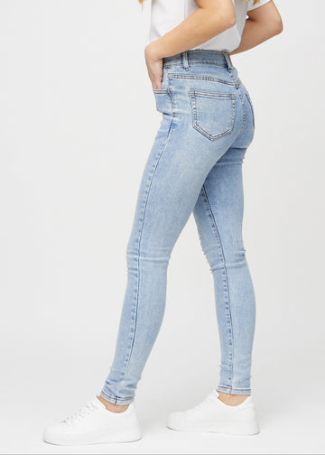 Skinny jeans for women in light blue, color Waves. Side view on a model.