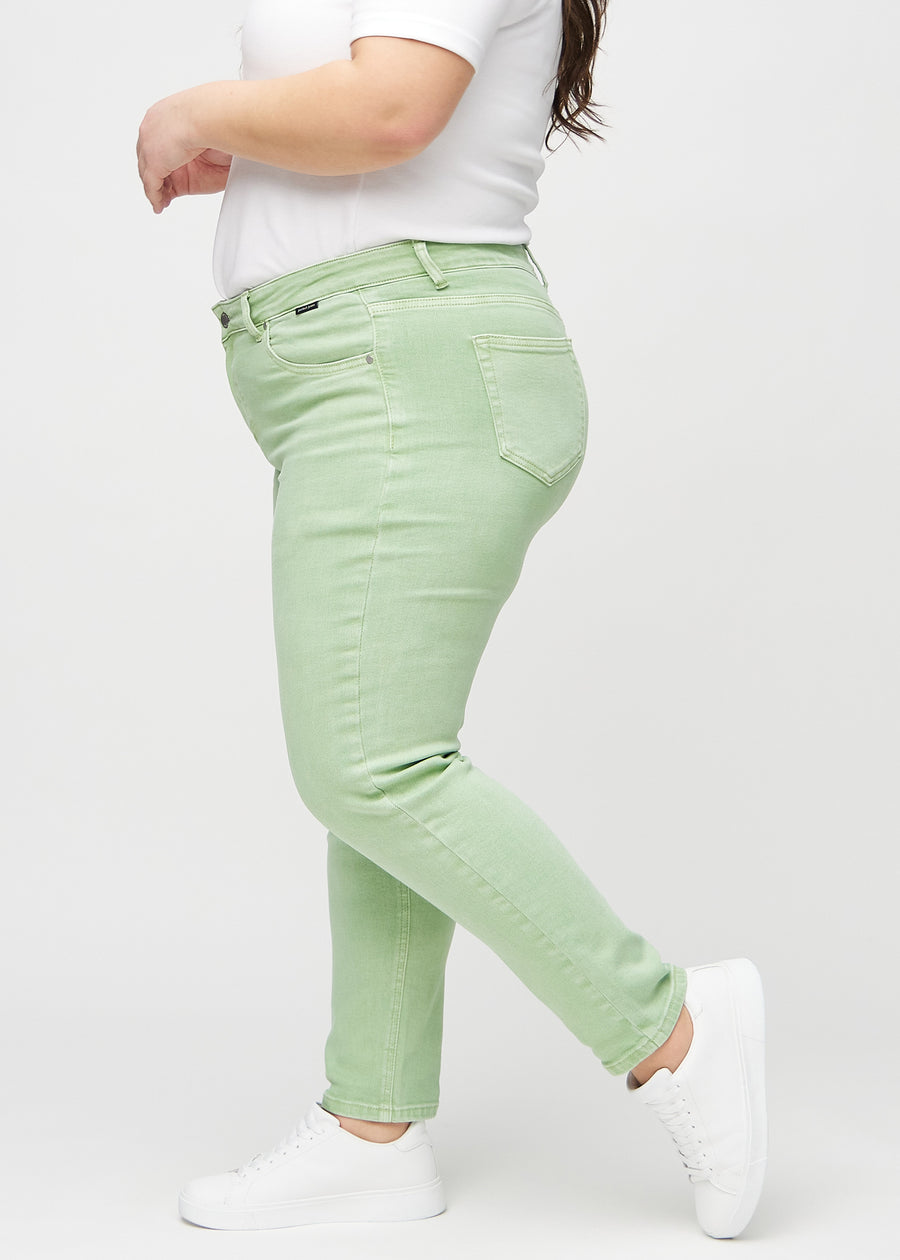 Slim jeans for women in light green, color Mints. Side view on a plus-size model.