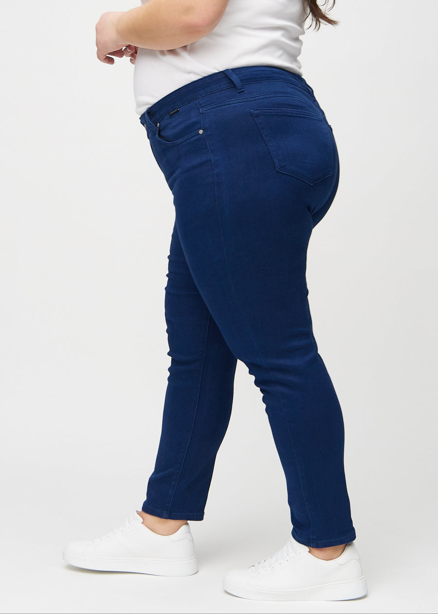 Slim jeans for women in dark blue, color Royals. Side view on a plus-size model.