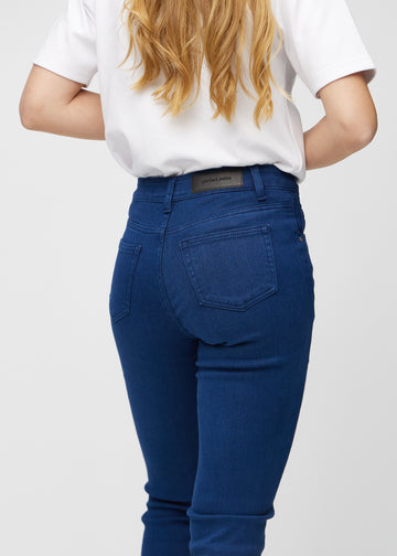 Slim jeans for women in dark blue, color Royals. Close-up back view on a model, showing the details.