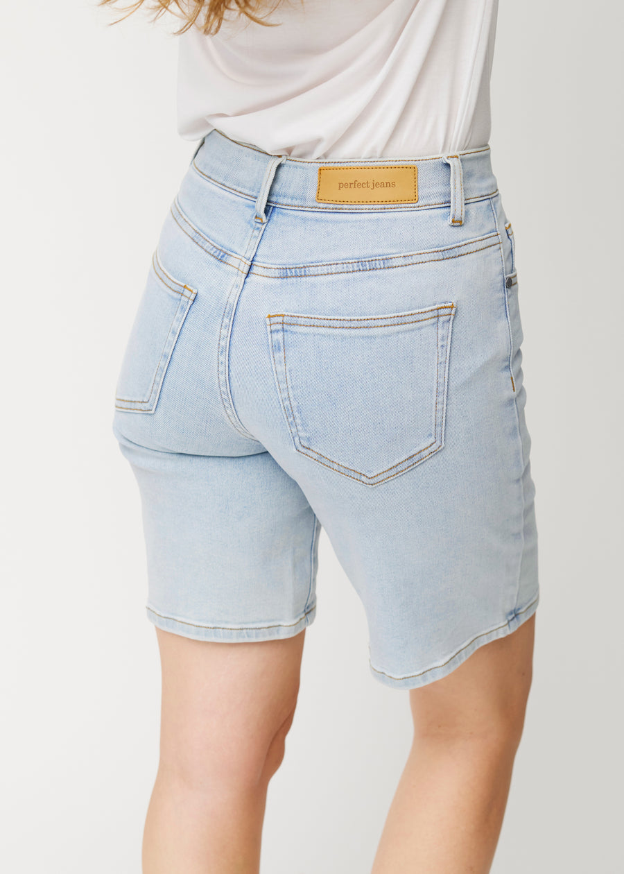 Close-up back view of light blue Waves denim shorts for women, showing the fit and details.