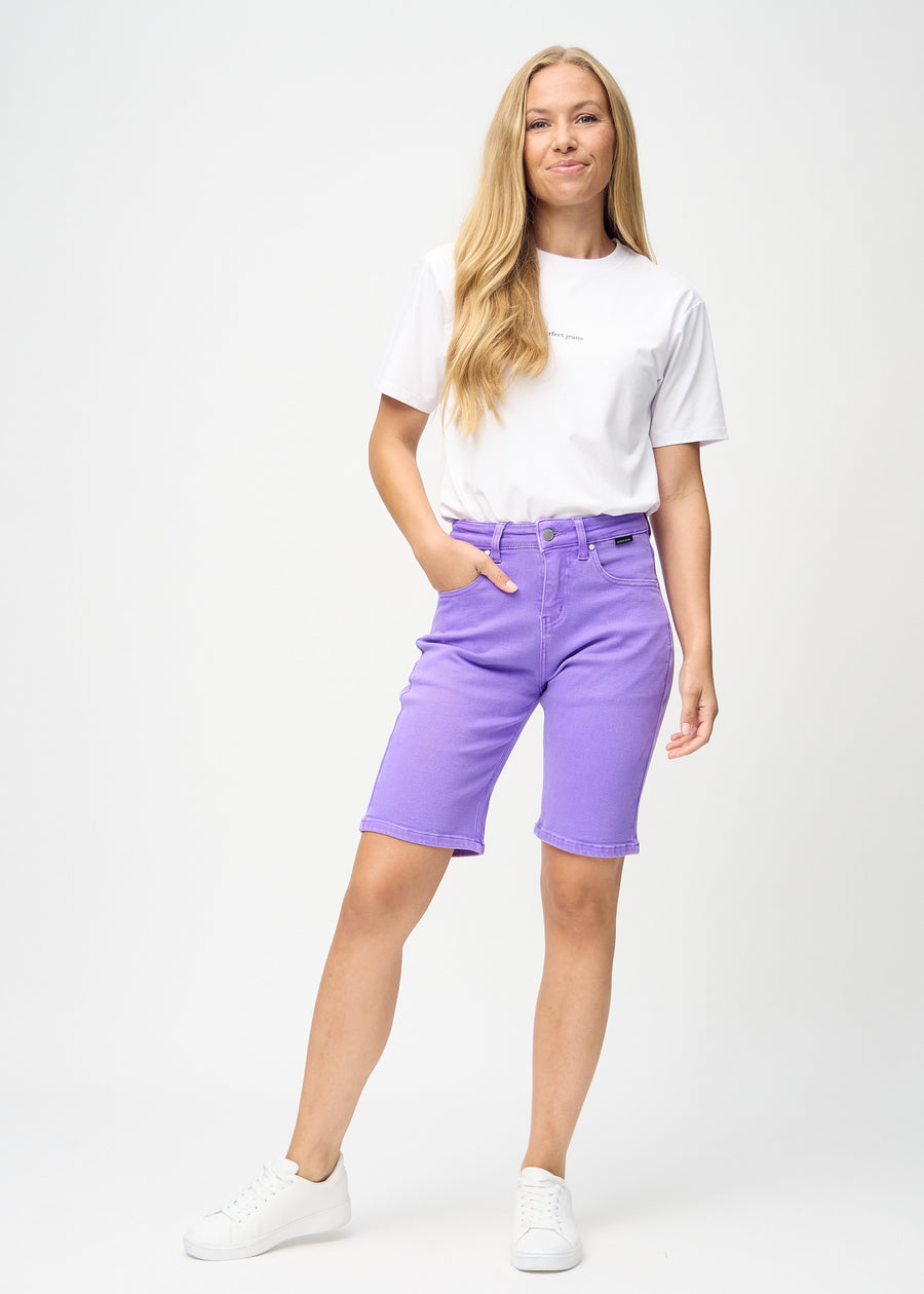 Full-length image of model in purple regular middle shorts.