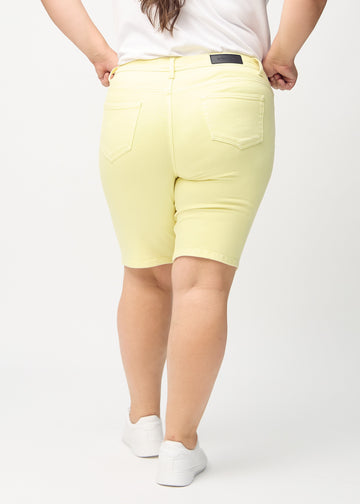 Light yellow skinny middle shorts seen from the back on a plus-size model, so the full product can be seen.