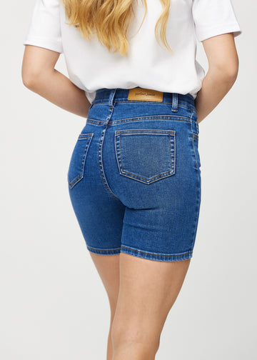 Dark denim skinny short shorts seen from the back close up to show details.