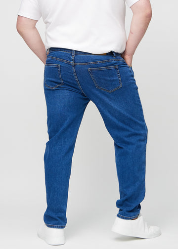 Dark blue denim regular jeans seen from the back on a plus-size model, so the full product can be seen.