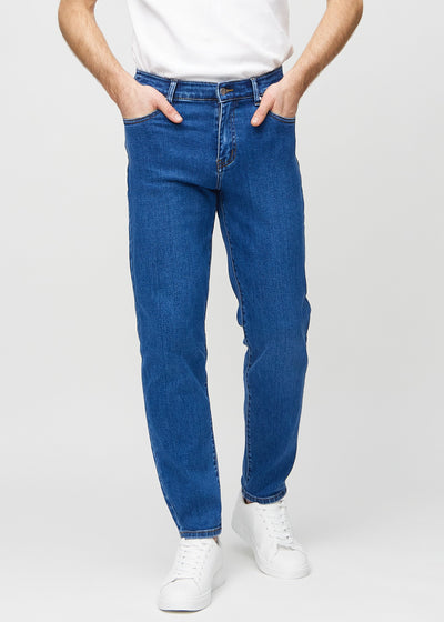Dark blue denim regular jeans, model name Oceans, which falls straight down the leg, seen from the front.