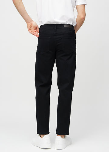Black regular jeans seen from the back, so you can see the entire product.