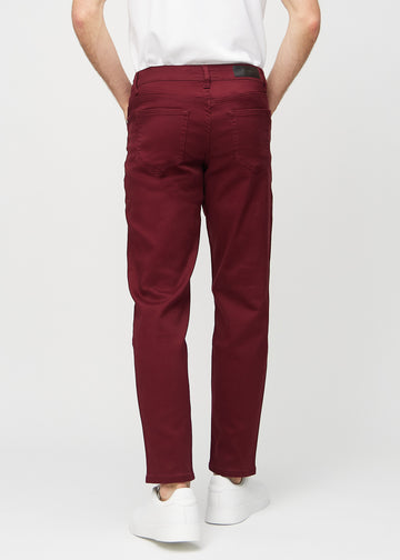 Dark red regular jeans seen from the back, so the entire product can be seen.