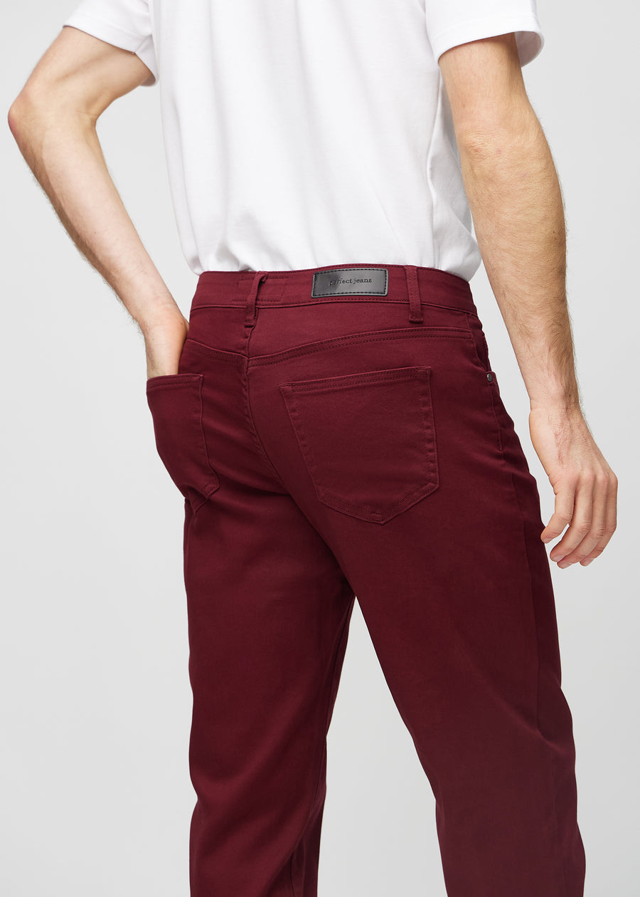 Dark red regular jeans seen from the back close up to show details.