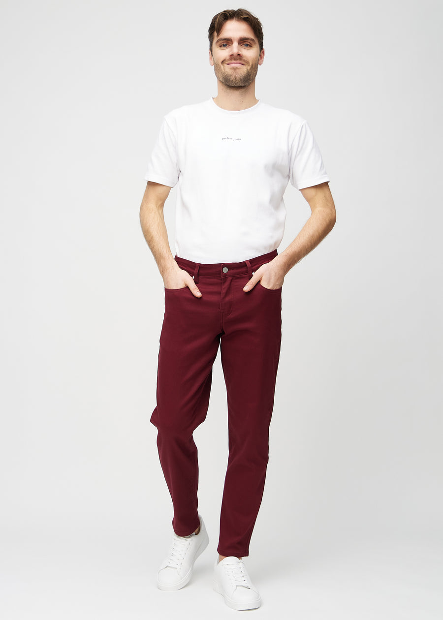 Full image of a model in dark red regular jeans.