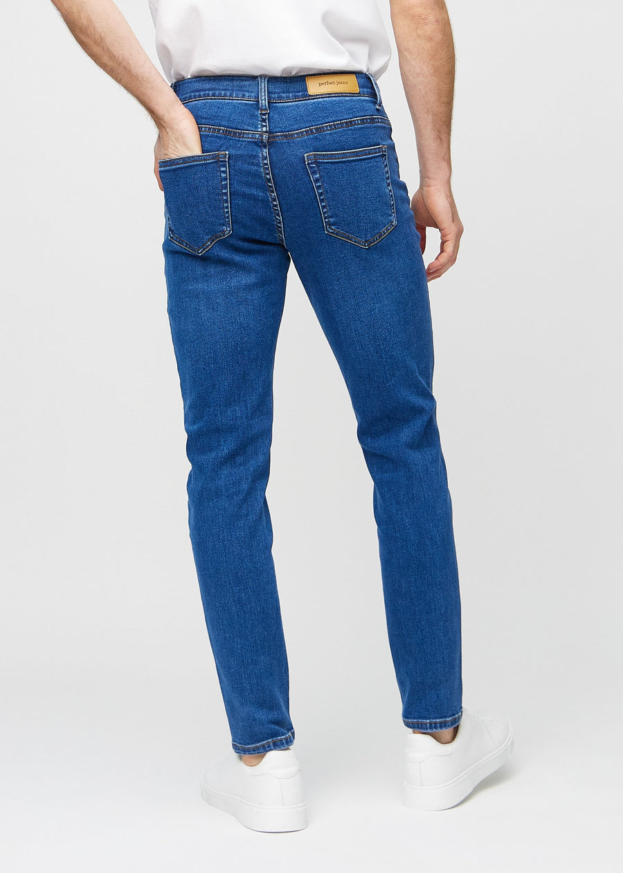 Dark blue denim slim jeans viewed from the back to show the full product.