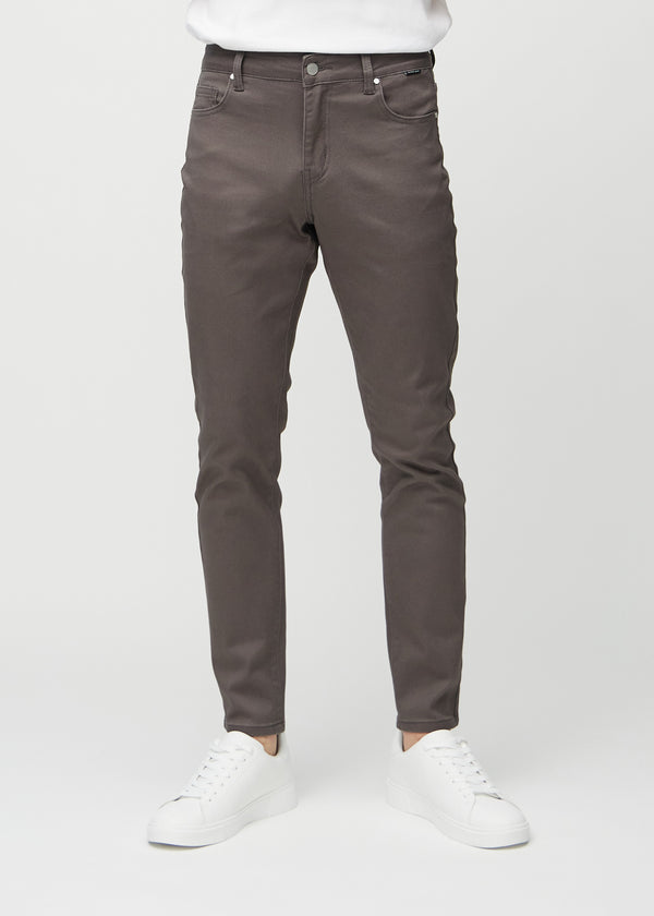 Grey-brown slim jeans, model name Thunders, fitted closely along the legs, front view.