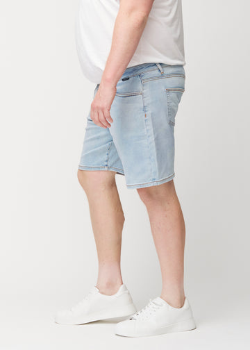 Light blue denim shorts for men in the colour Waves with a regular fit seen from the side on a plus-size model.