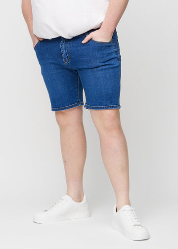 Dark denim middle-slim shorts, which fit straight along the thigh and end just above the knee on a plus-size model, seen from the front.