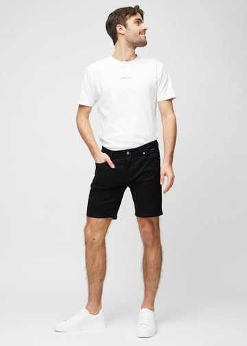 Full image of a model wearing black middle-slim shorts.