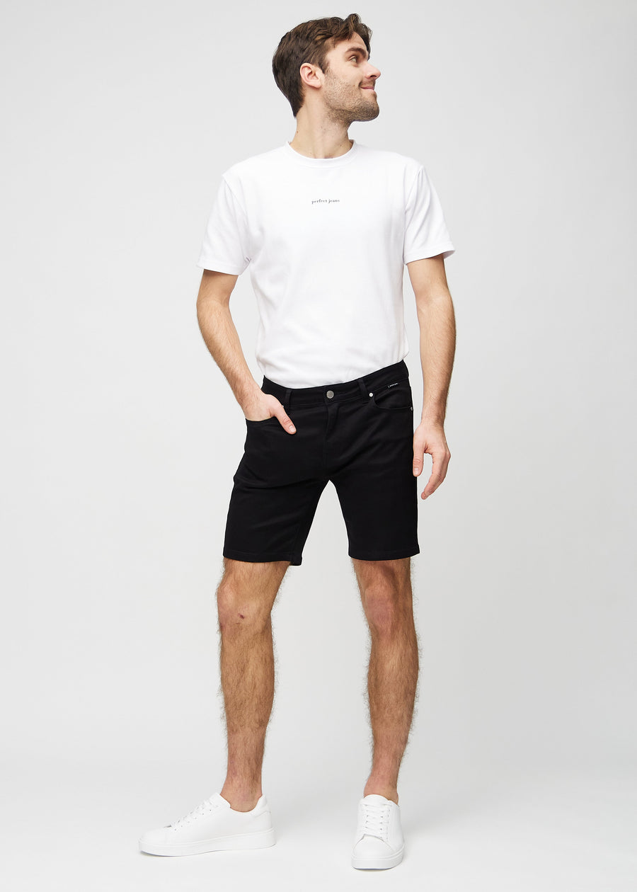Full image of a model wearing black middle-slim shorts.