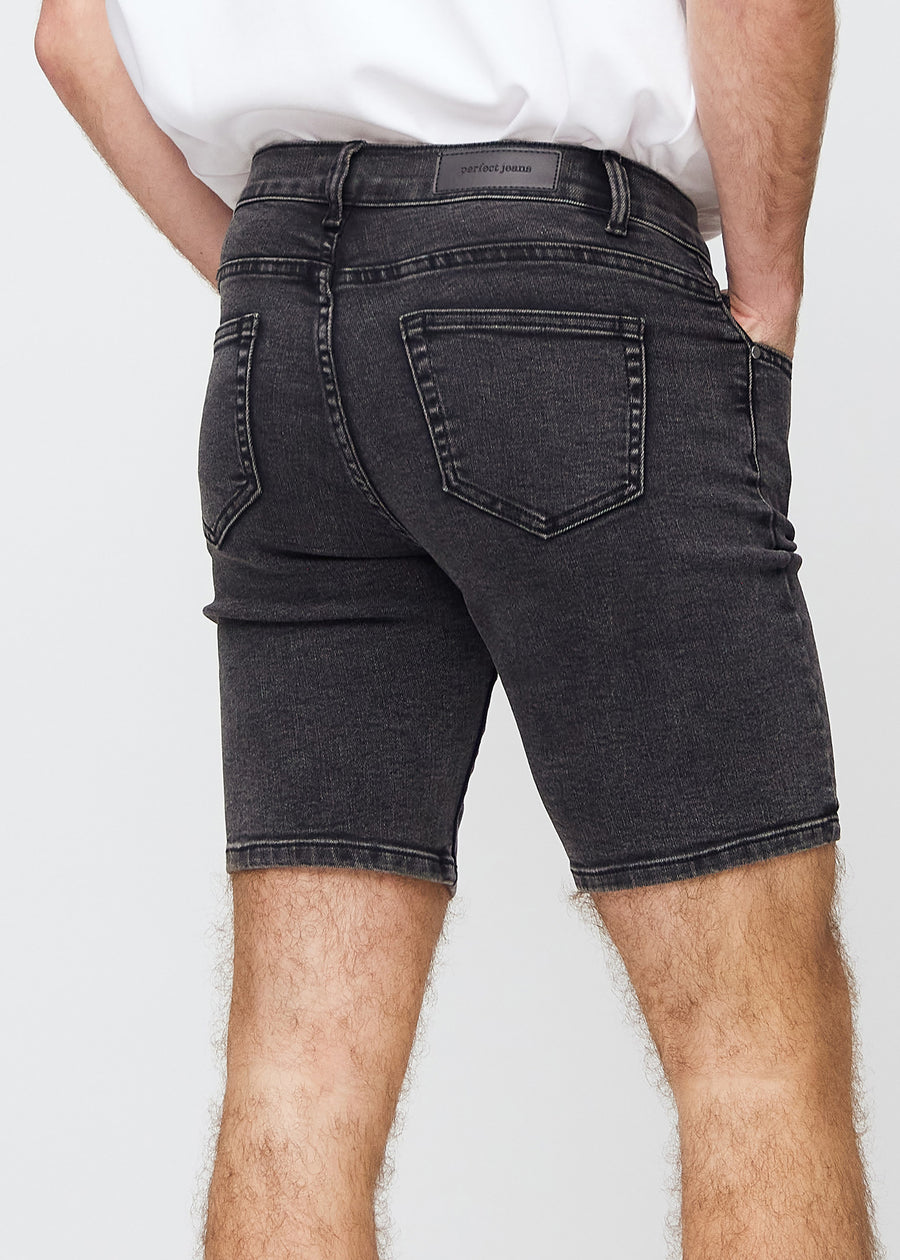 Dark grey denim middle-slim shorts seen from the back in a close-up to show details.